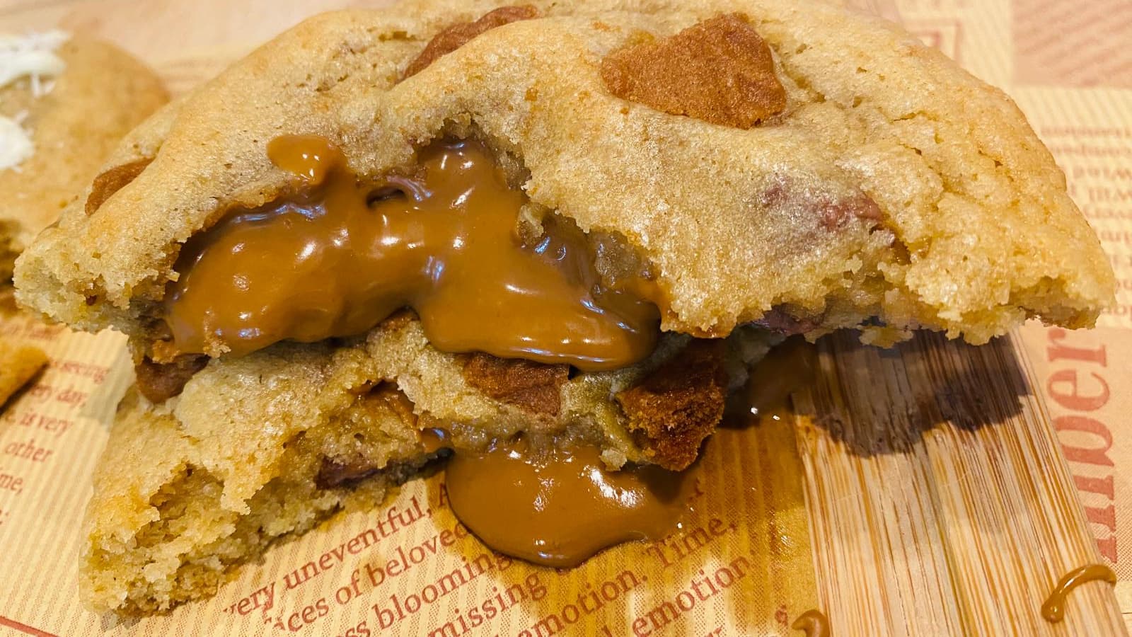 Biscoff cookie torn open with molten caramelised spread oozing out