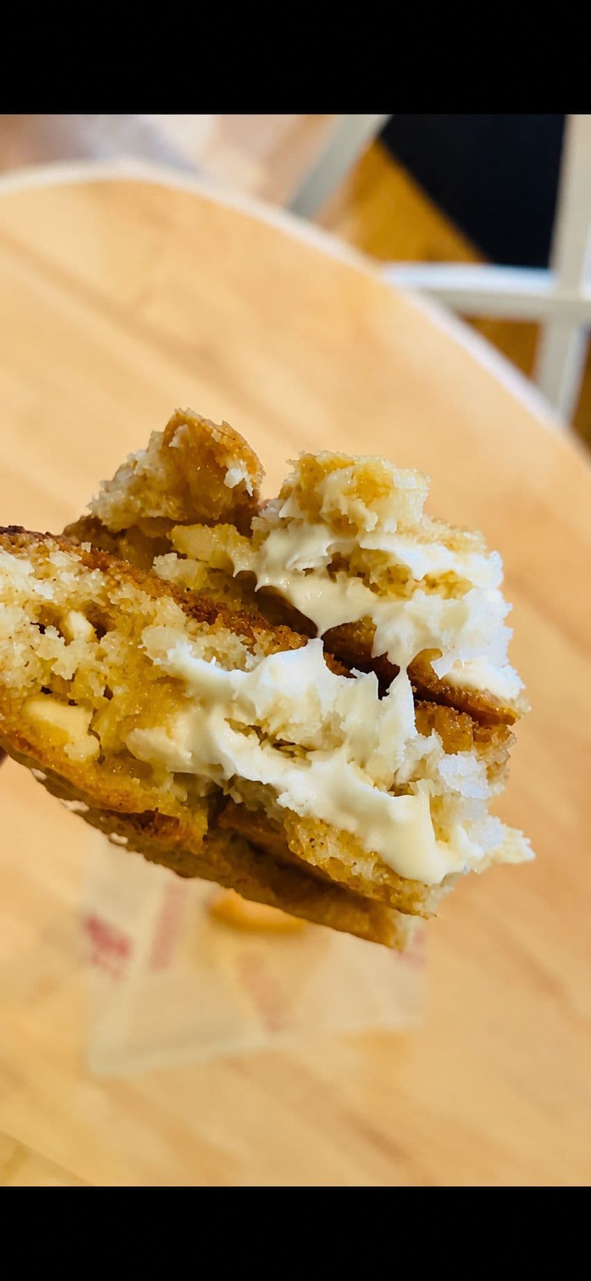 Bounty cookie split open with coconut filling and white chocolate
